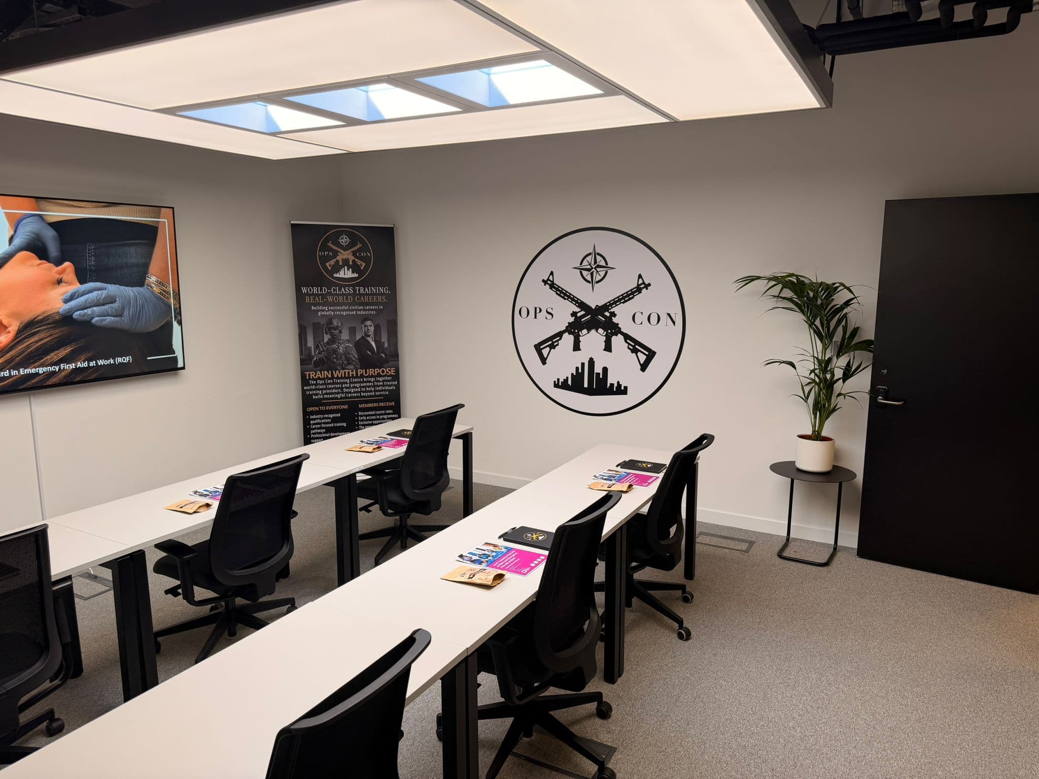 Training room interior with desks and Ops Con branding